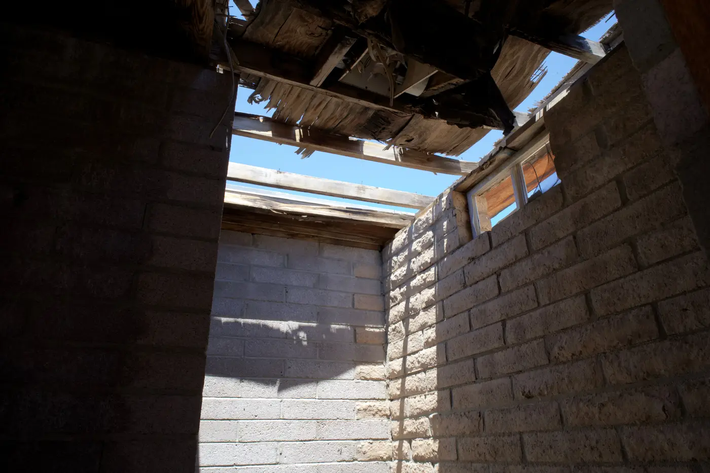 Roof and ceiling showing active water damage before repair